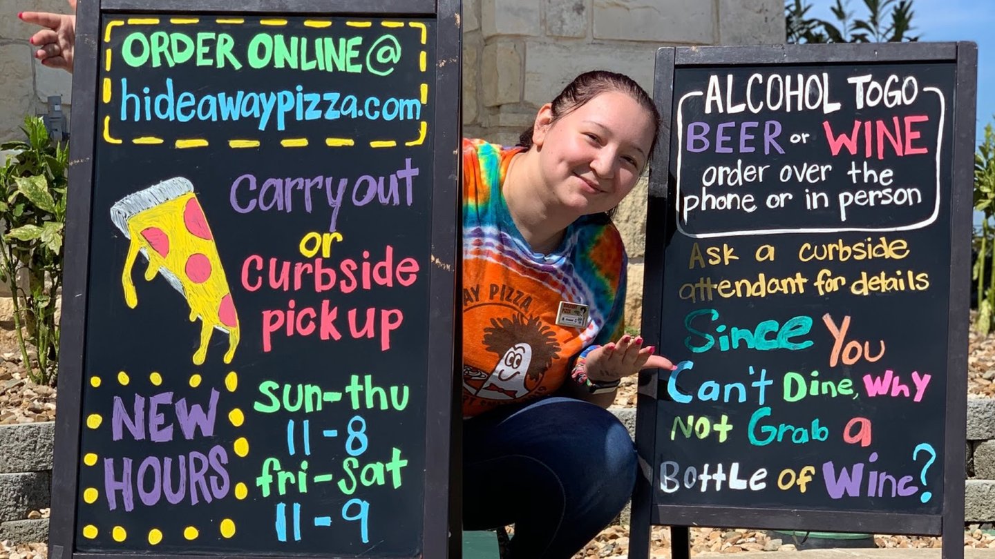 a blackboard sign outside of a building